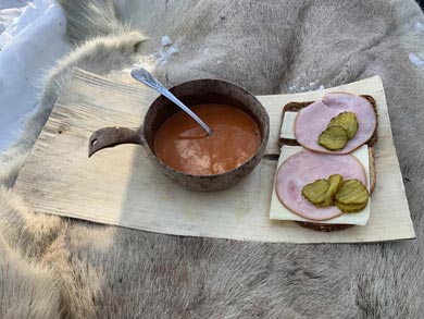 The snowmobile guide prepares lunch for the group | Photo: Anthony Hammock
